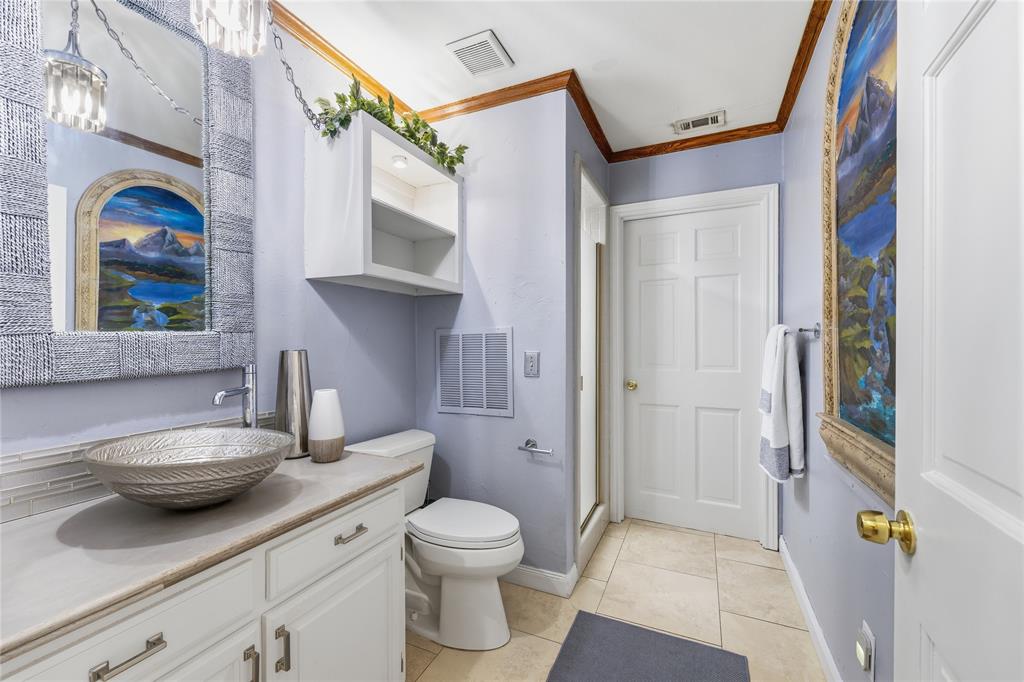 Bathroom offers designer bowl sink, concrete countertop, separate walk-in shower. This bathroom is multipurpose, great for downstairs guest and has pool access!