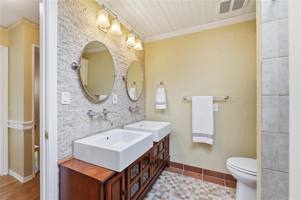 This third full bath has two access points one from the bedroom and another off the hallway.