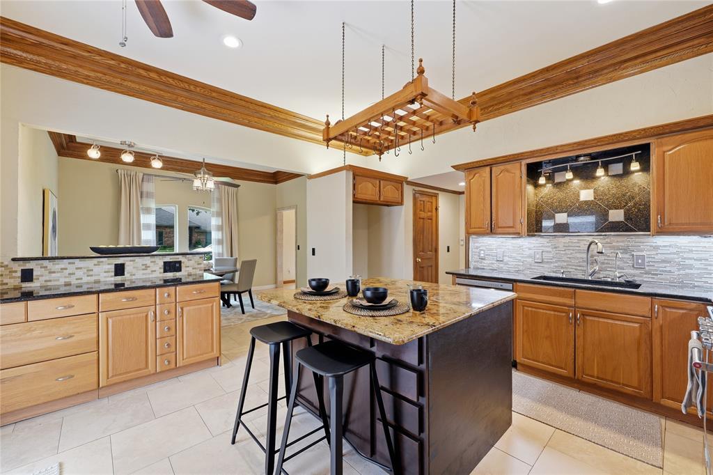This kitchen offers stainless steel appliances, double oven, granite countertops, pantry and smal storage room.