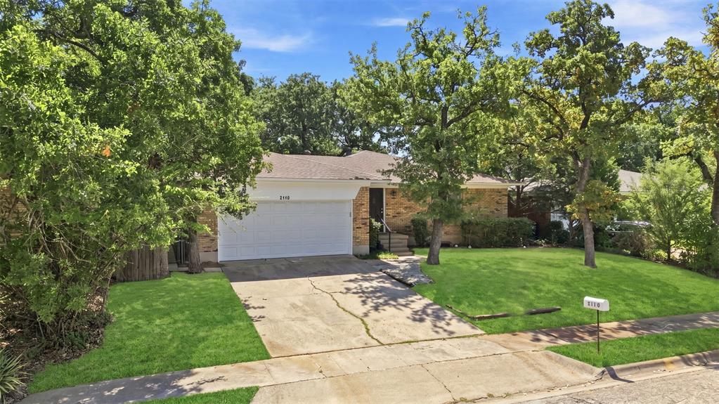 Single-story brick residence with an attached two-car garage