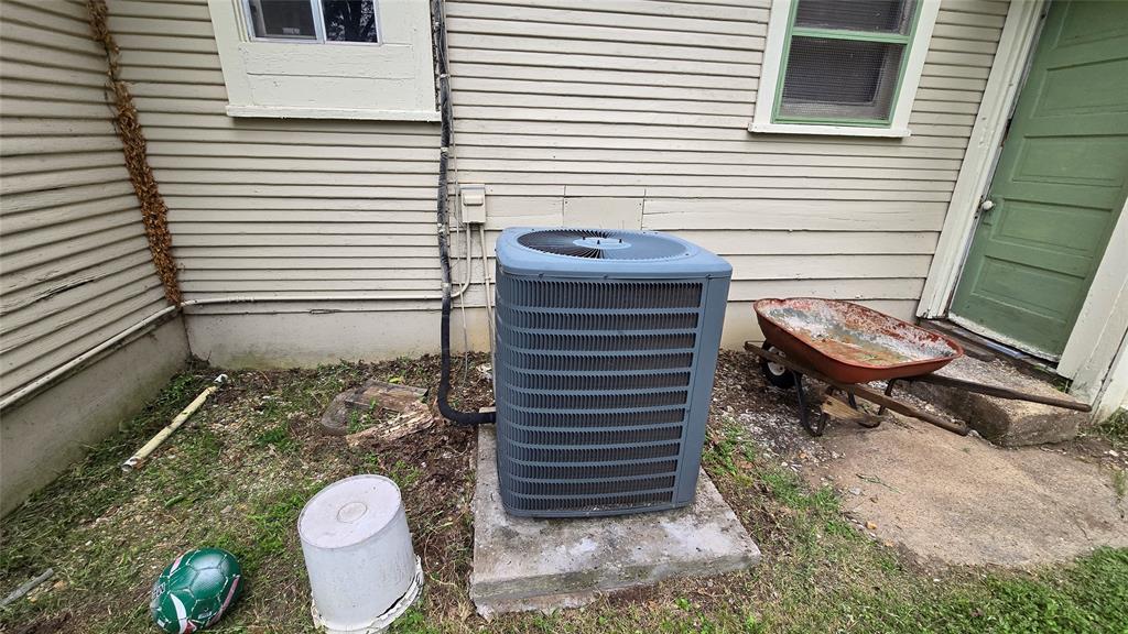 Exterior siding with an integrated HVAC condenser unit on a concrete pad