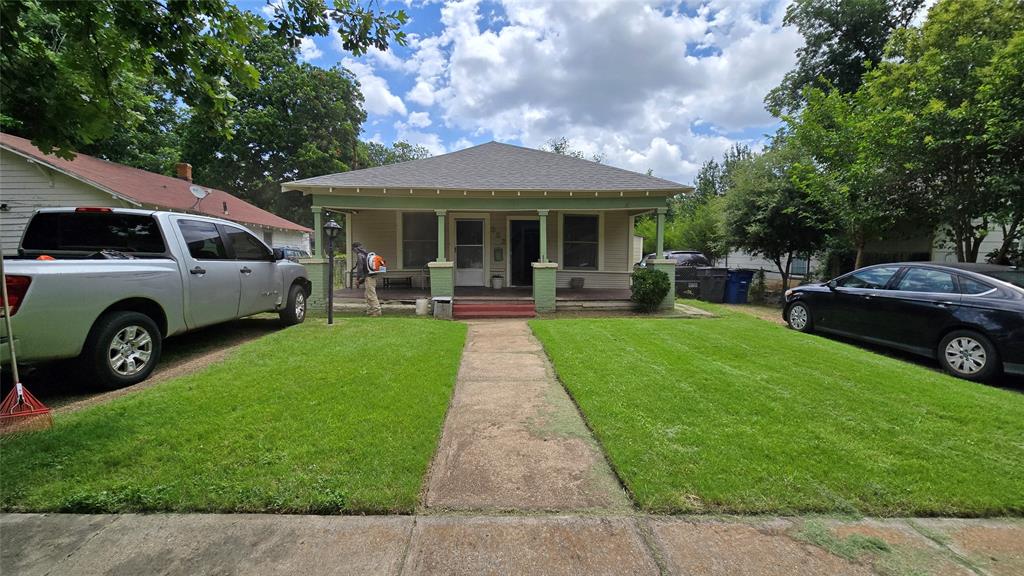 Single-story residence featuring a covered front porch, tapered support columns, a hip roof, and a concrete walkway