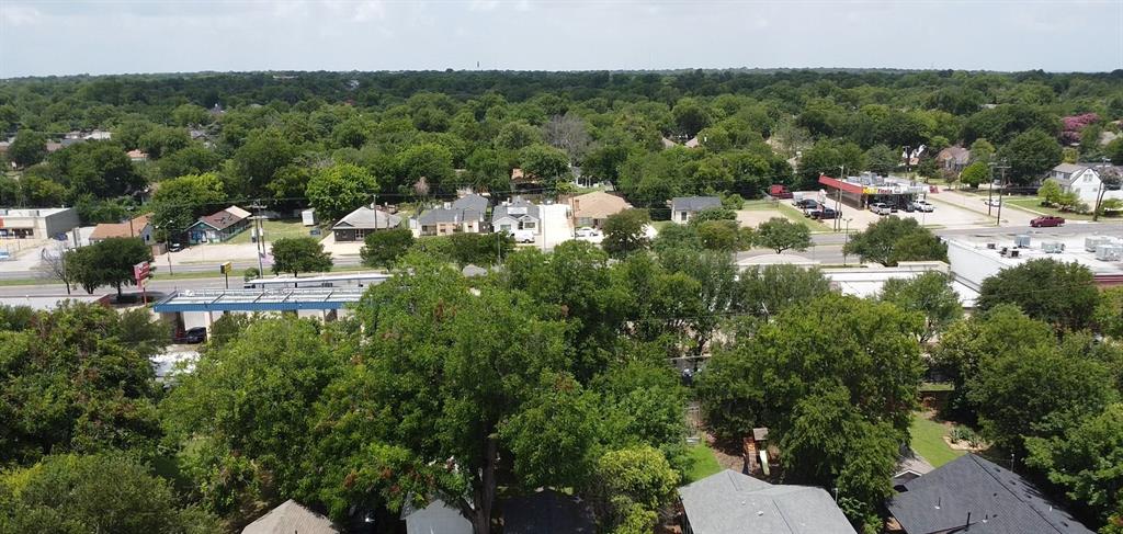 Aerial perspective featuring established residential surroundings with mature tree canopy