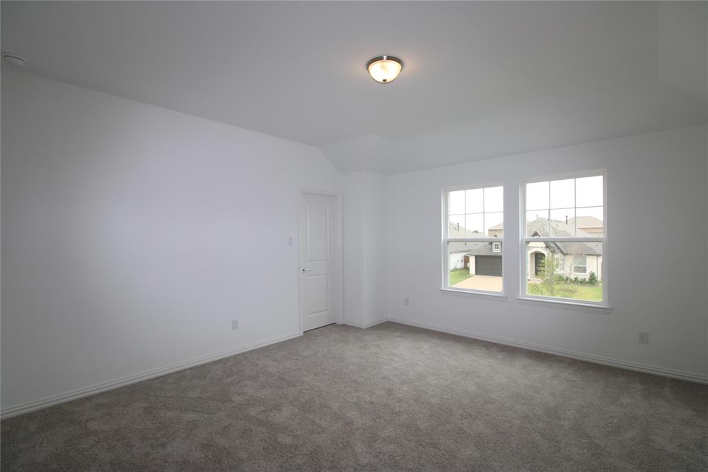 Neutral-toned carpeting, crisp white walls, flush-mount ceiling light fixture, and double-paned windows