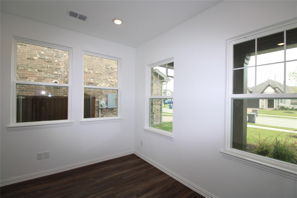 Bright interior featuring multiple windows with grid muntins, wood-finish flooring, and recessed lighting