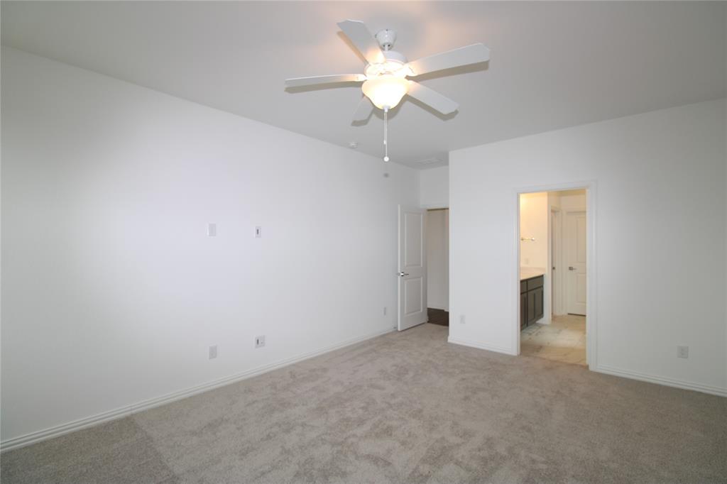 Neutral-toned carpeted flooring, white interior walls, and a ceiling-mounted fan with integrated lighting