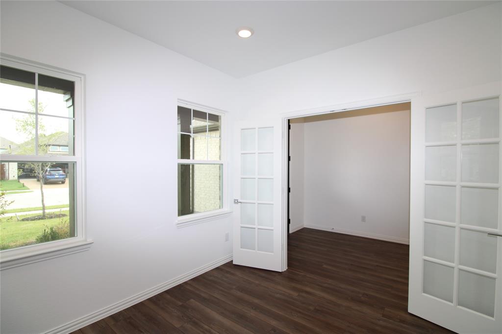 Interior space featuring wood-finish flooring, recessed lighting, double French doors with glass panes, and windows with grids