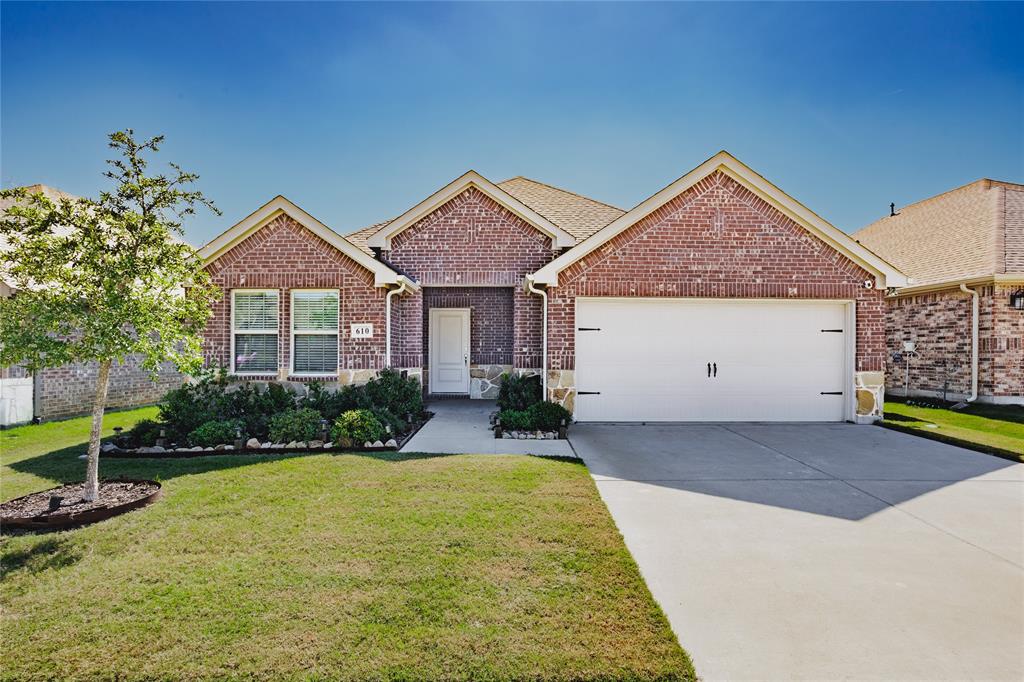 Brick exterior featuring stone accents, gabled roofline, concrete driveway, and covered entryway Brick exterior featuring stone accents, gabled roofline, concrete driveway, and covered entryway