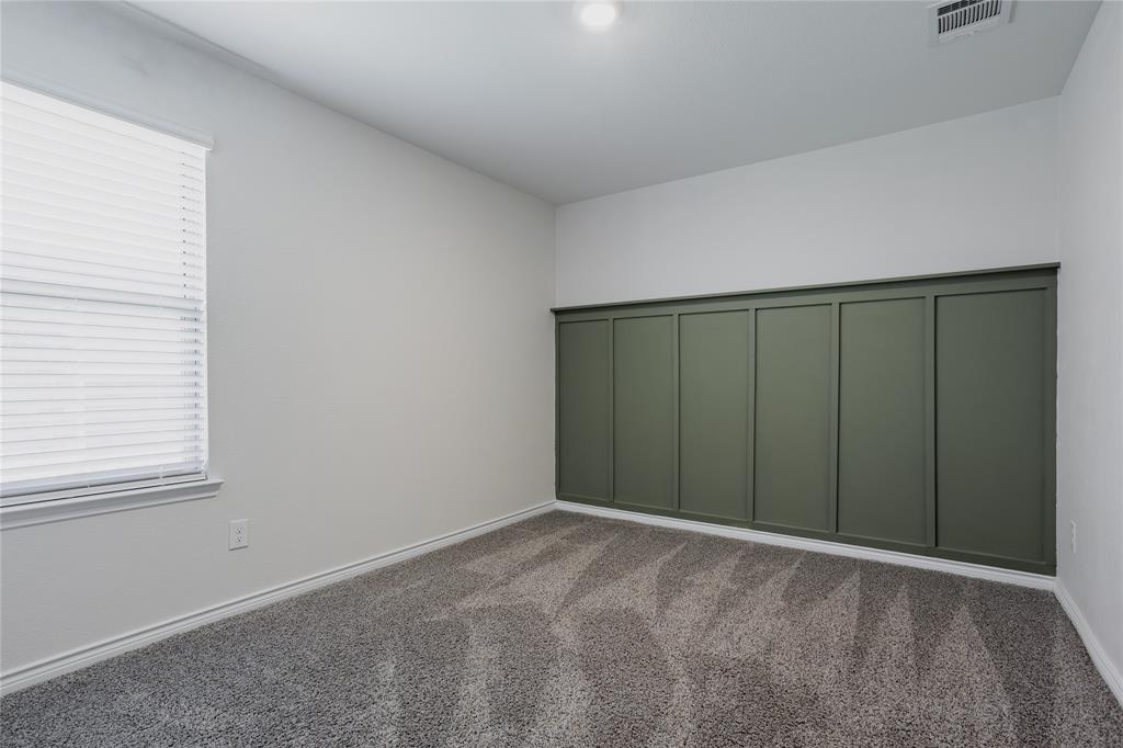 Room featuring wall-to-wall carpeting, window blinds, and an olive-toned paneled accent wall