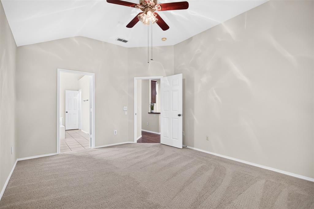 Vaulted ceilings featuring a multi-blade lighted ceiling fan and neutral wall finishes