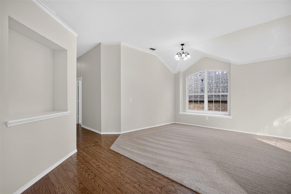 Vaulted ceilings, arched window with a deep sill, built-in wall niche, wood-finish flooring, and crown molding Vaulted ceilings, arched window with a deep sill, built-in wall niche, wood-finish flooring, and crown molding