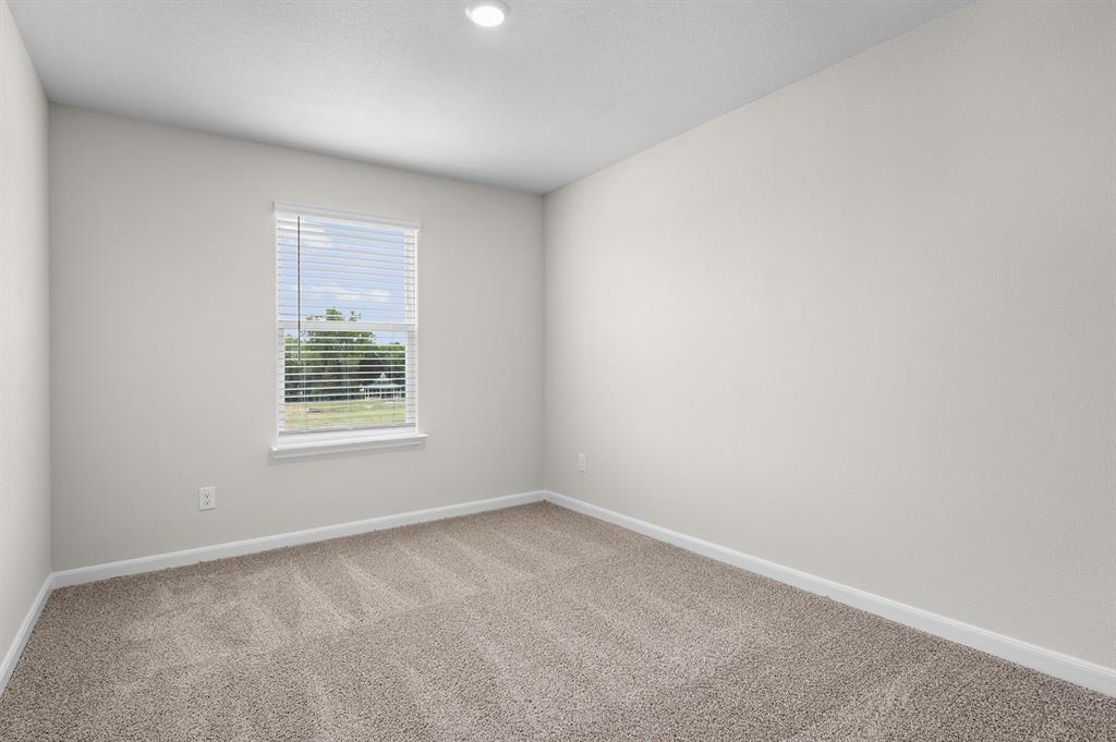 Empty room featuring baseboards and carpet floors