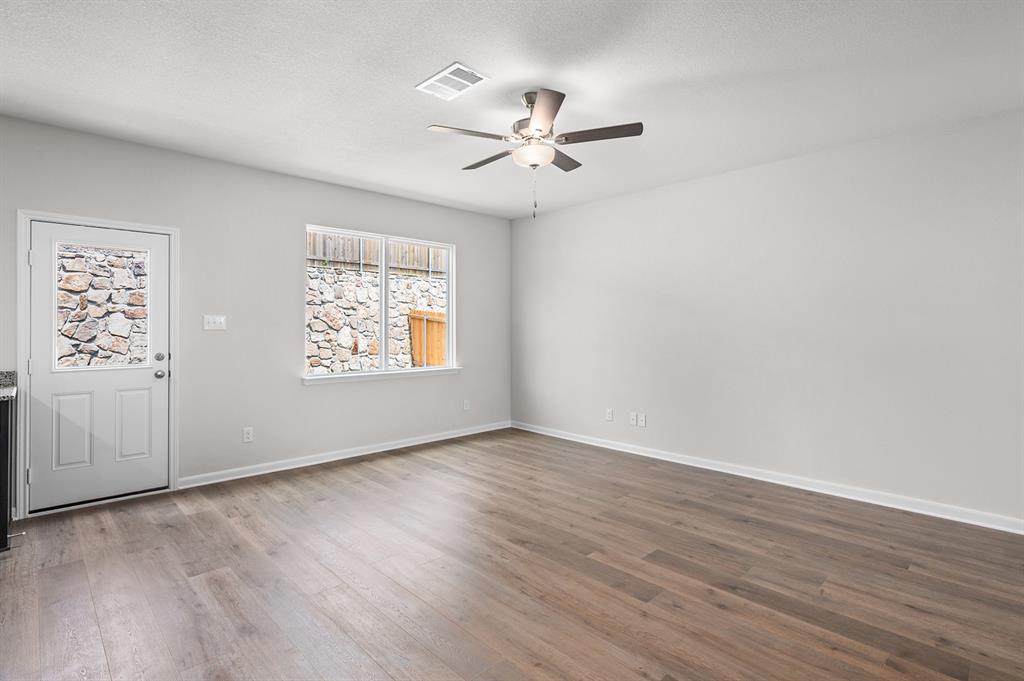 Foyer entrance with light wood-style flooring, ceiling fan, and a textured ceiling