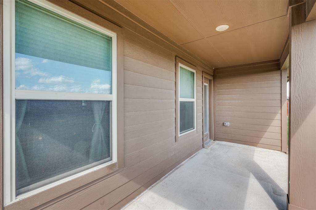 Covered patio featuring horizontal lap siding, recessed ceiling lighting, and dual windows with white trim