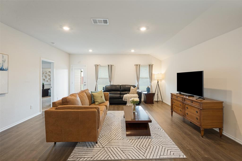 Open-concept interior featuring wood-finish flooring, recessed lighting, and neutral wall tones