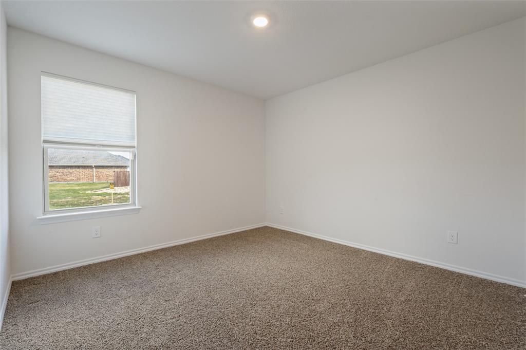 Neutral-toned wall-to-wall carpeting, crisp white walls, recessed ceiling lighting, and a window featuring a pleated shade