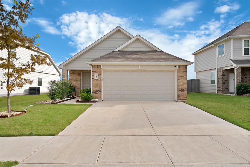 Single-story residence featuring a brick and horizontal siding exterior, attached two-car garage, and a concrete driveway