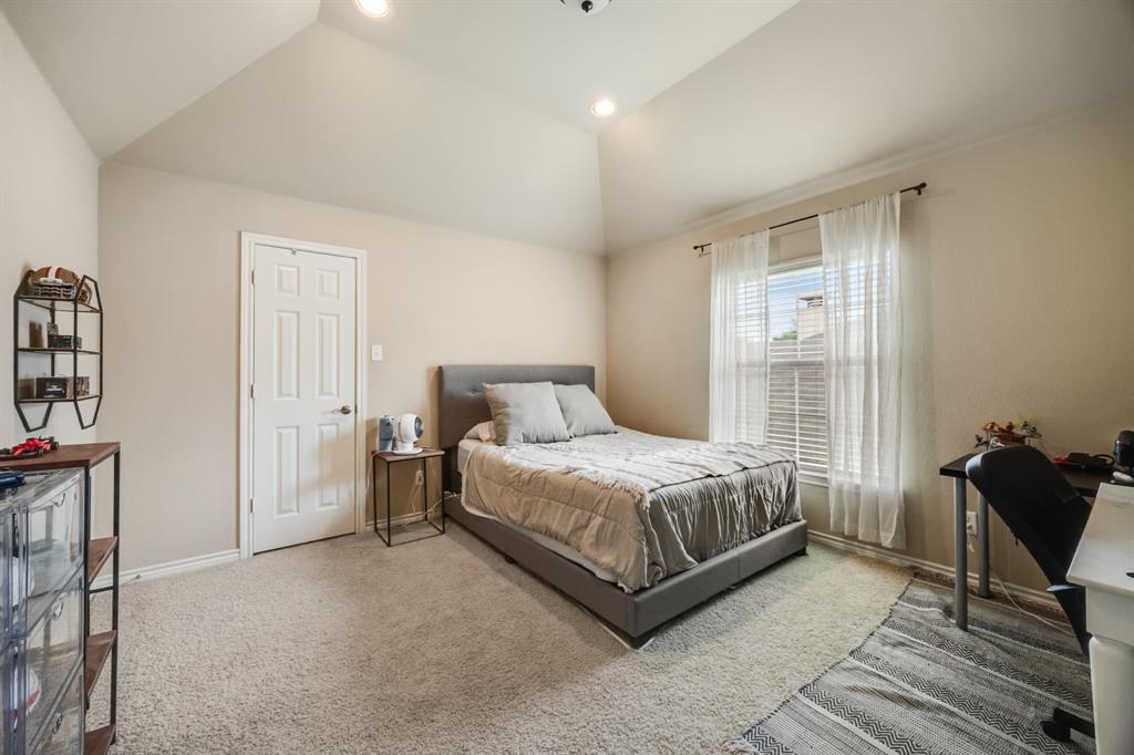 Carpeted bedroom featuring lofted ceiling, recessed lighting, and a desk