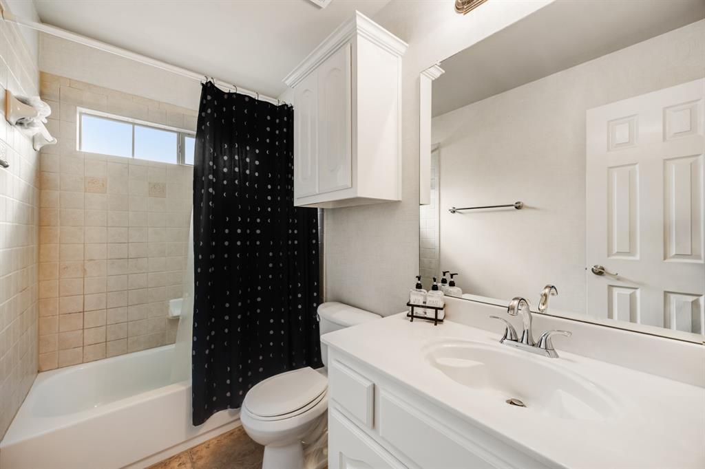 Full bathroom with shower / tub combo with curtain and vanity