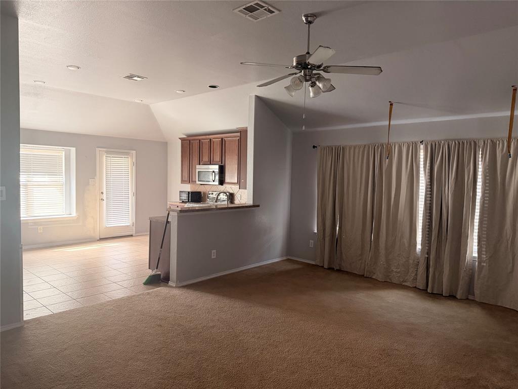 Vaulted ceilings featuring a brushed nickel ceiling fan with integrated lighting, recessed lighting, tile flooring, and built-in cabinetry Vaulted ceilings featuring a brushed nickel ceiling fan with integrated lighting, recessed lighting, tile flooring, and built-in cabinetry