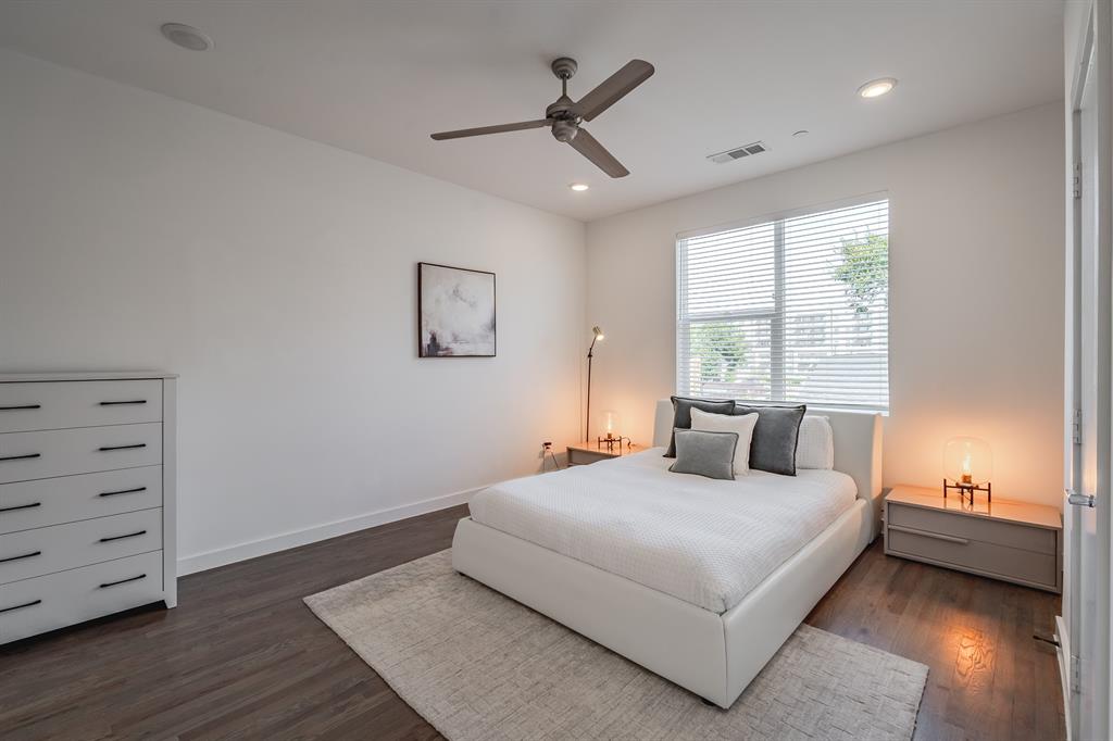 Dark wood-finish flooring, recessed lighting, matte-finish ceiling fan, and horizontal window blinds