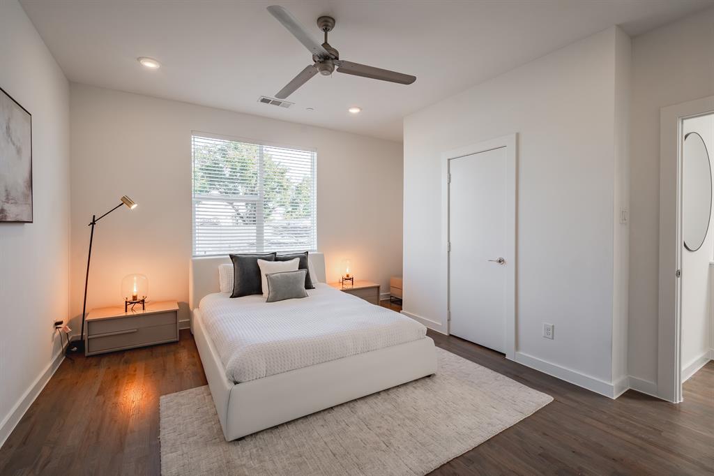 Wood-finish flooring, recessed lighting, ceiling fan, and large window with horizontal blinds