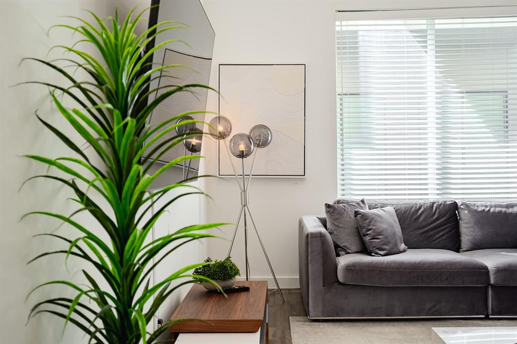 Neutral wall palette with wood-finish flooring and horizontal window blinds