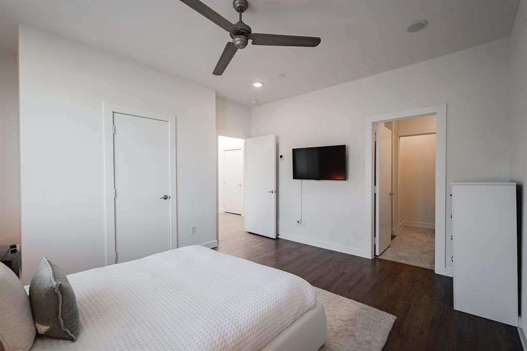 Interior space featuring wood-finish flooring, a contemporary ceiling fan, recessed lighting, and multiple interior doorways