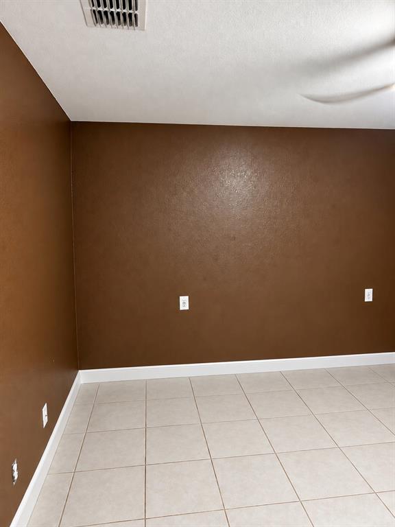 Neutral-toned ceramic tile flooring paired with solid-colored wall finishes