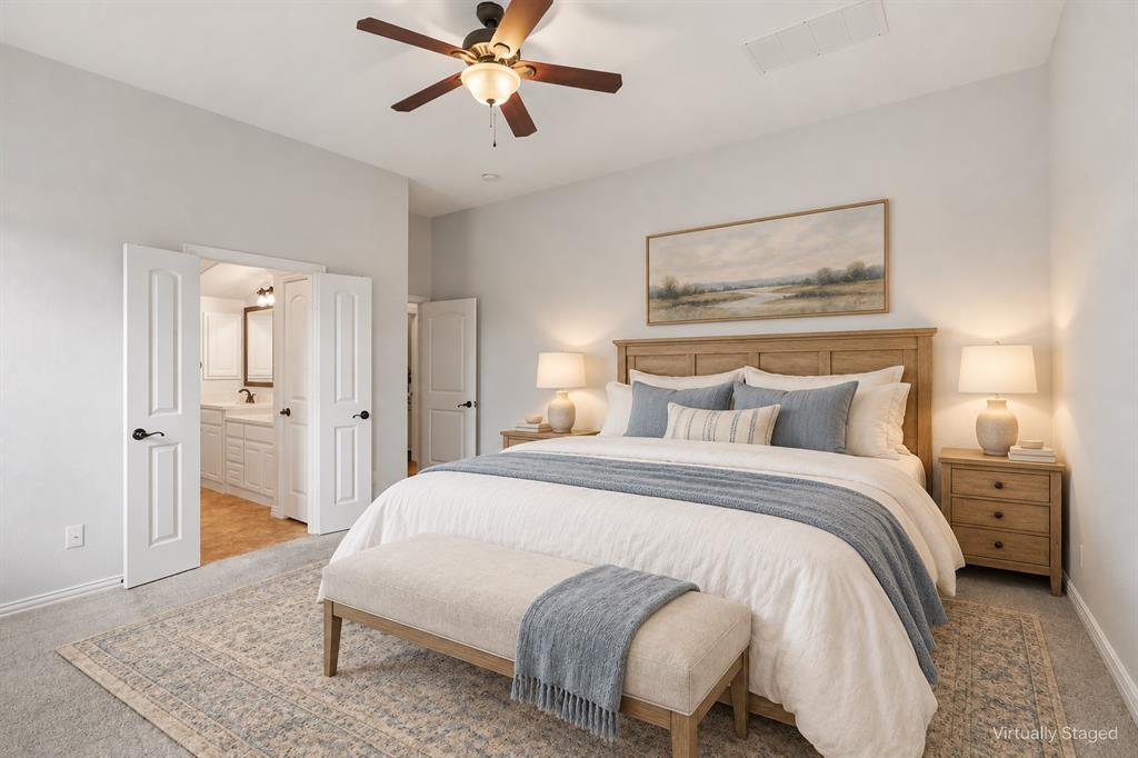 Spacious room featuring neutral carpeting, a central ceiling fan with integrated lighting, and multi-panel interior doors Spacious room featuring neutral carpeting, a central ceiling fan with integrated lighting, and multi-panel interior doors