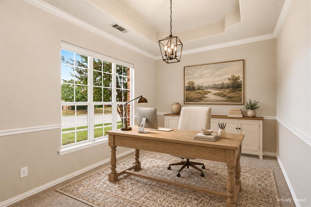 Tray ceiling featuring crown molding, large divided-light window, and metal geometric pendant lighting