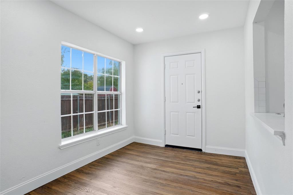 Dining room with large window and door to backyard