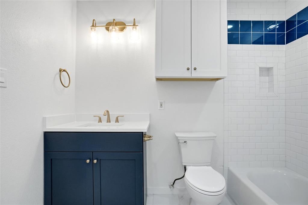 Updated primary Bath with new vanity, toilet, updated tile and fixtures