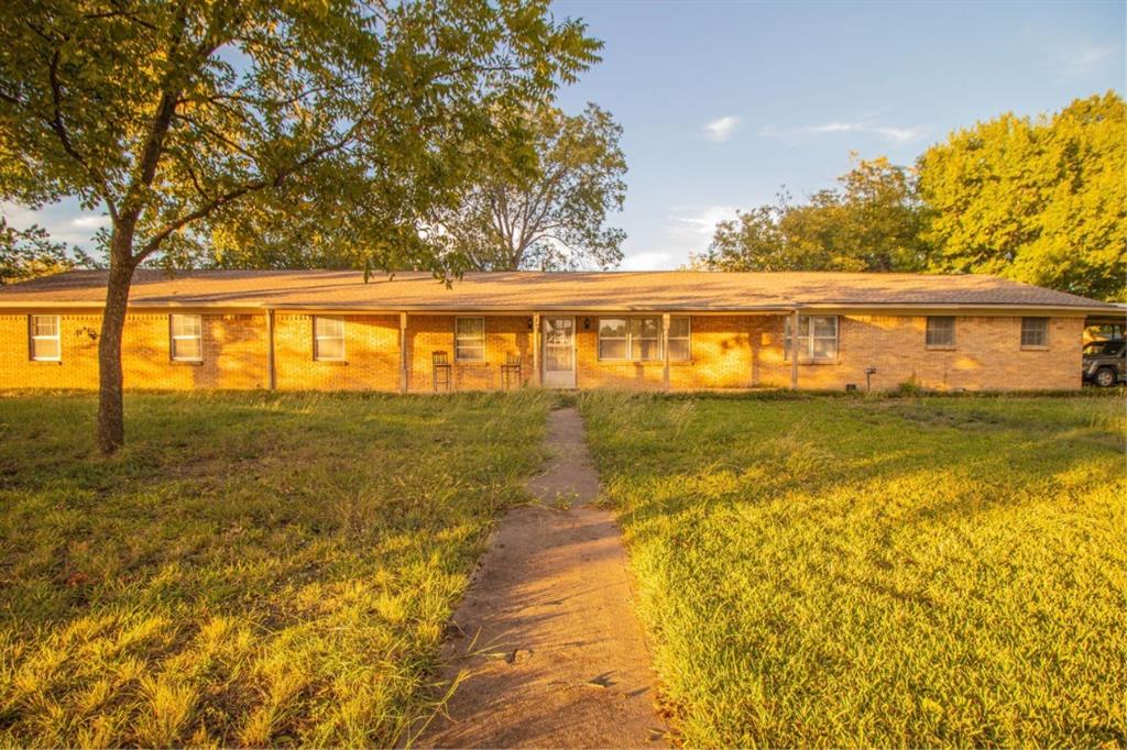 Single-story brick exterior featuring a covered front porch and concrete walkway