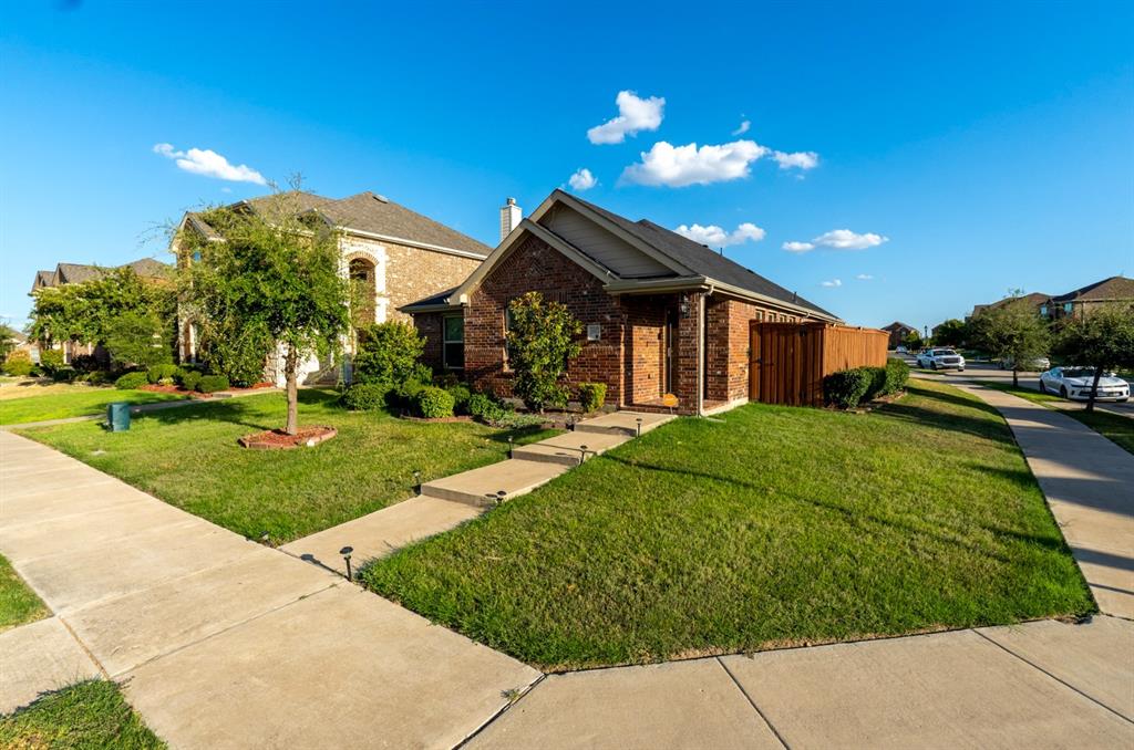 Single-story brick exterior featuring a gable roof, covered entryway, and a concrete walkway