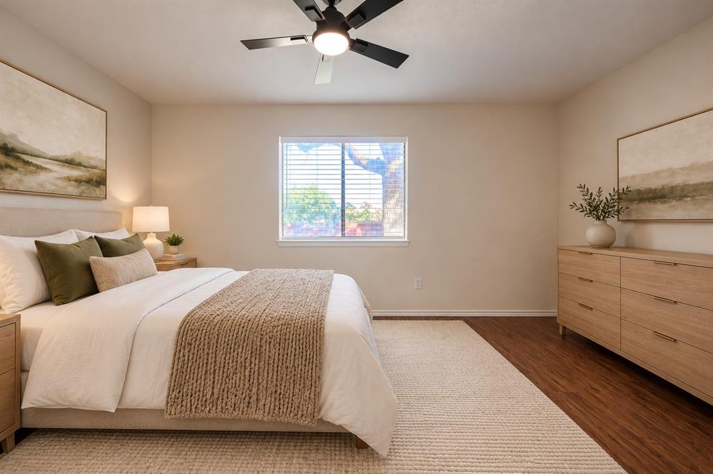 Neutral wall paint, wood-finish flooring, and a ceiling fan with integrated lighting