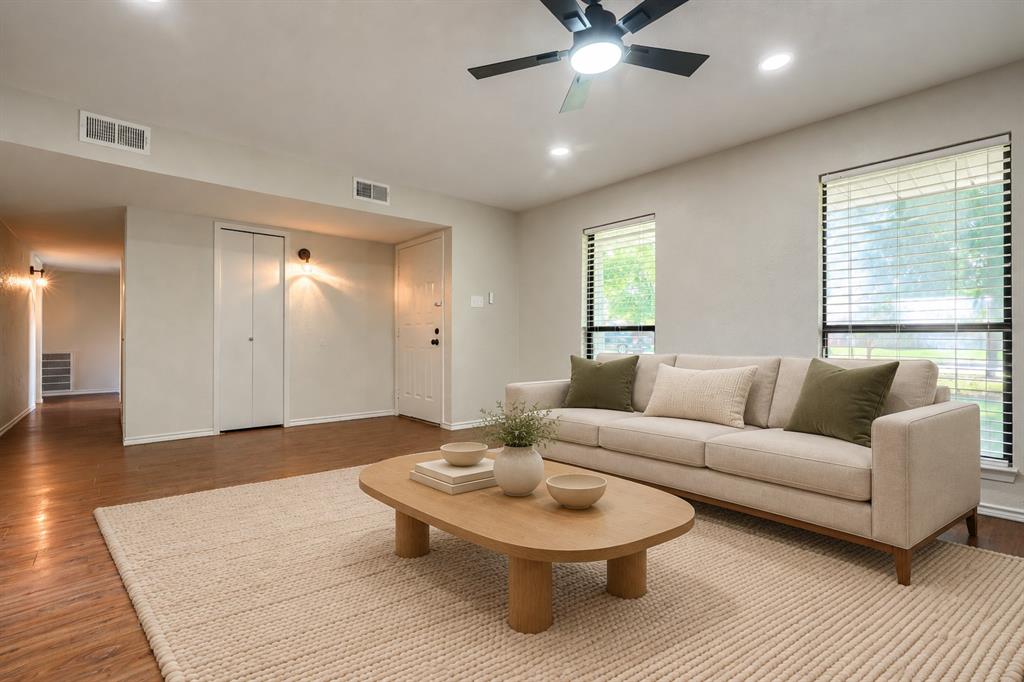 Wood-finish flooring, recessed lighting, ceiling fan with integrated light, and large windows with horizontal blinds Wood-finish flooring, recessed lighting, ceiling fan with integrated light, and large windows with horizontal blinds