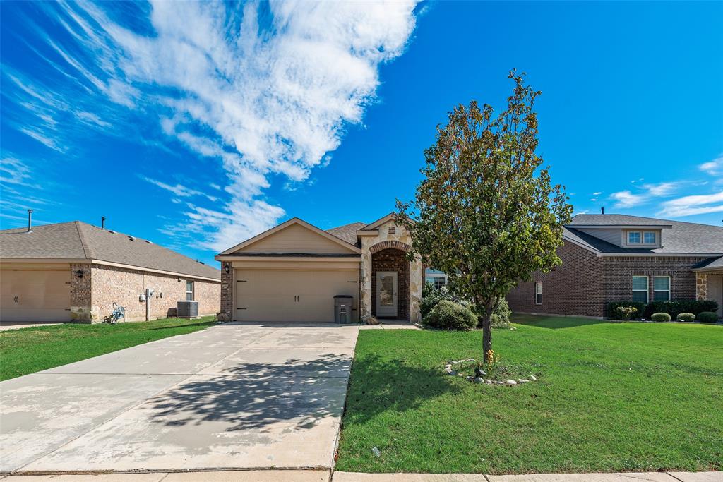 Single-story residence featuring a front-facing attached garage, stone and siding exterior, arched covered entryway, and a concrete driveway