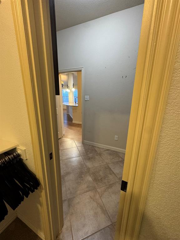 Tiled flooring featuring large-format ceramic tiles with a neutral stone pattern