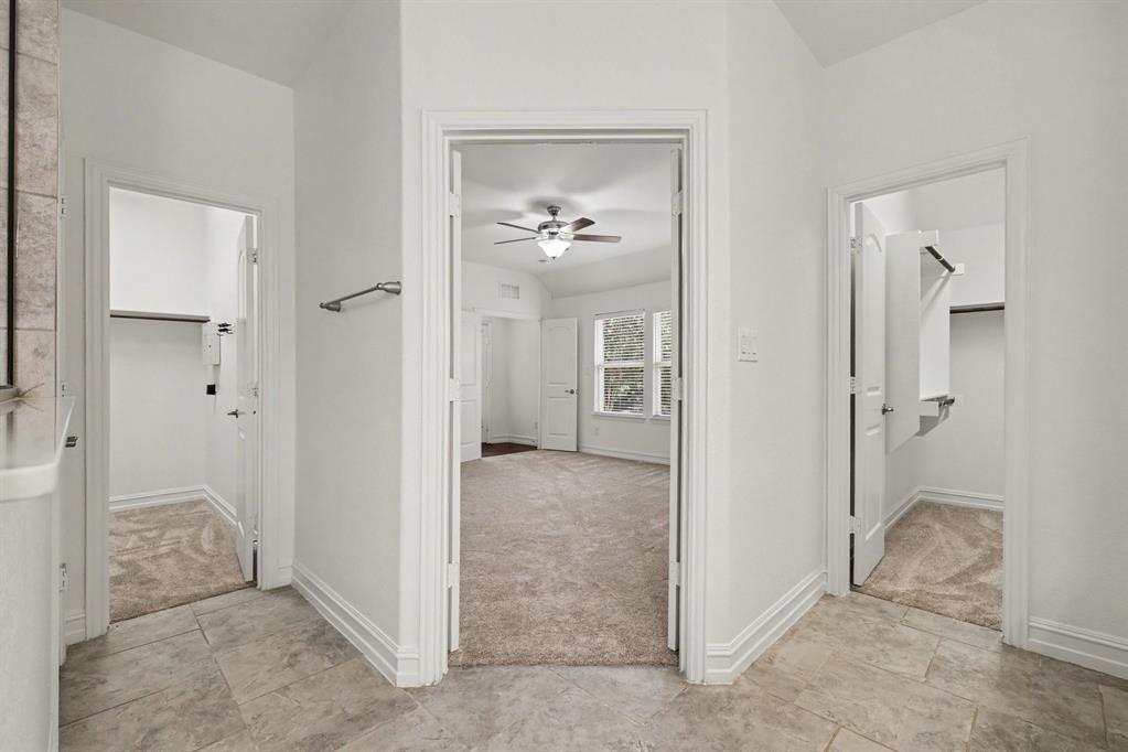 Inside primary bath, to the left is one closet, separate water closet and to right the other walk in closet!