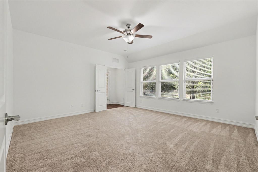 Primary Bedroom overlooking back yard and green space;