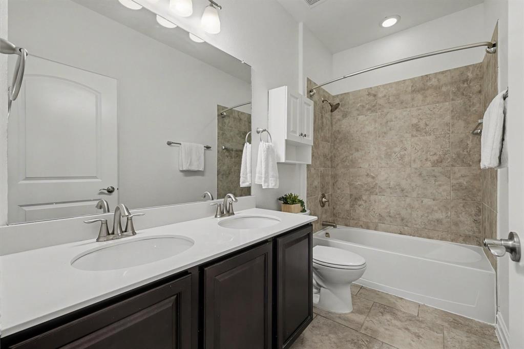 Hall bath with double sinks and new shower head.