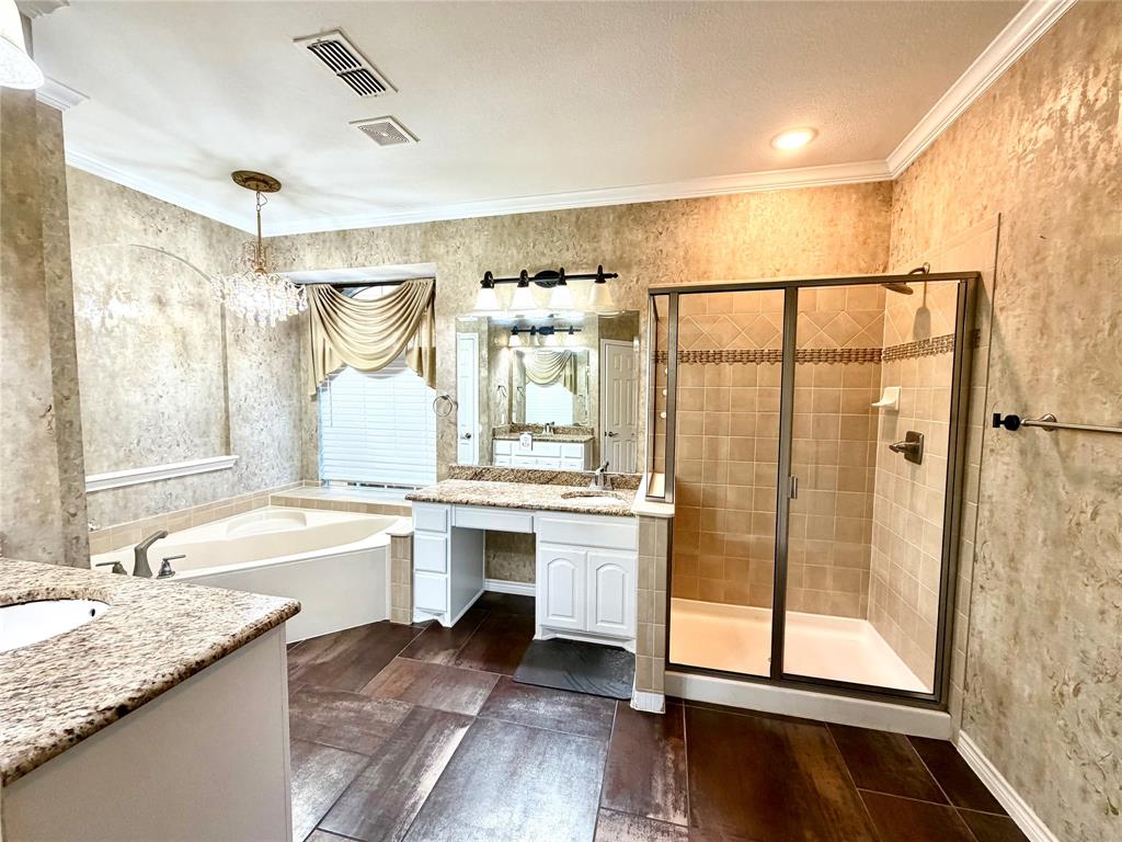 Bathroom featuring wood-finish flooring, white cabinetry with stone-surface countertops, a soaking tub, and a separate glass-enclosed shower with tiled walls