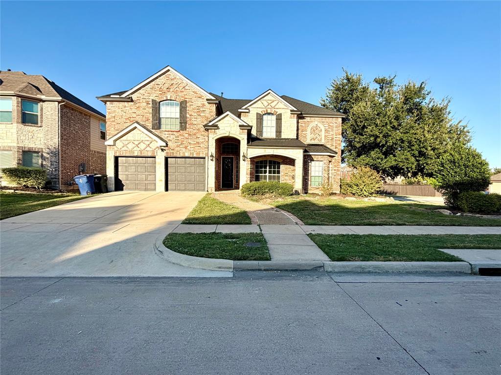 Brick exterior with decorative stone accents, arched entryway, multi-gabled roofline, and an attached two-car garage Brick exterior with decorative stone accents, arched entryway, multi-gabled roofline, and an attached two-car garage