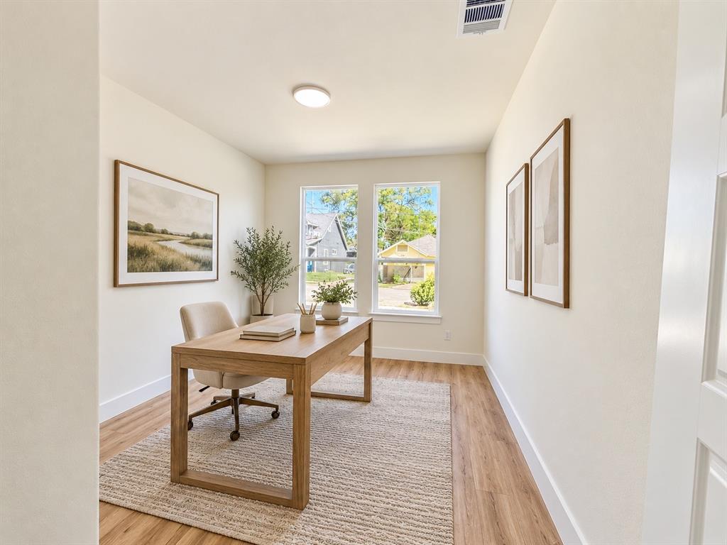 Neutral wall palette, wood-finish flooring, dual windows, and ceiling-mounted lighting