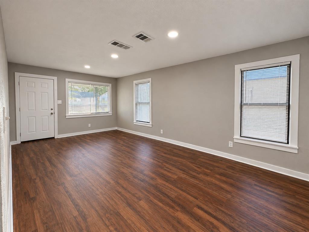 Spacious living area with abundant natural light and multiple windows. Spacious living area with abundant natural light and multiple windows.
