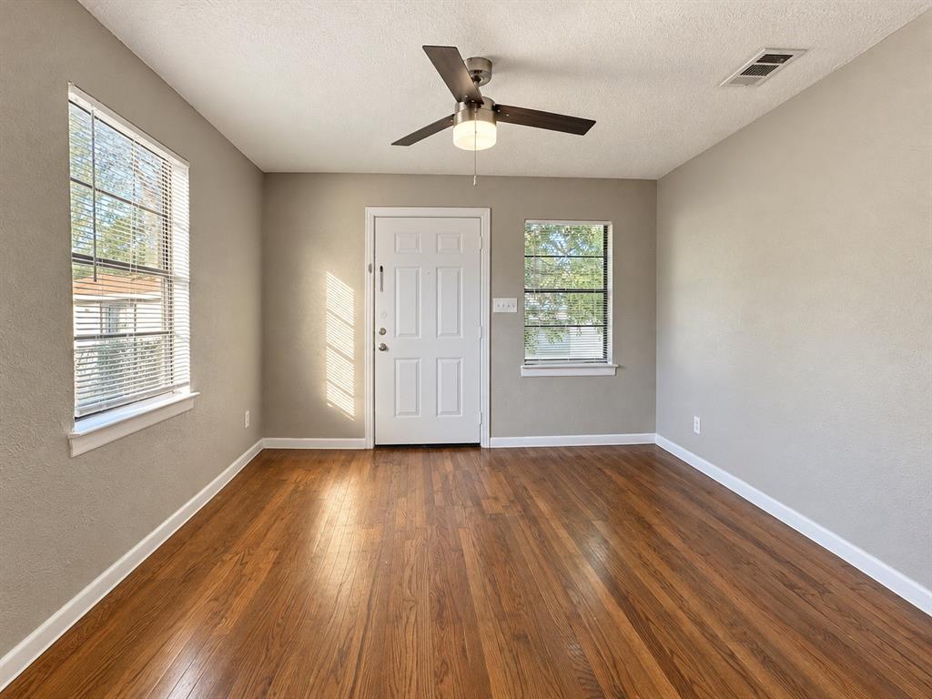 Bedroom / Office (Unstaged)Additional view of the room featuring wood flooring, ceiling fan, and natural light.