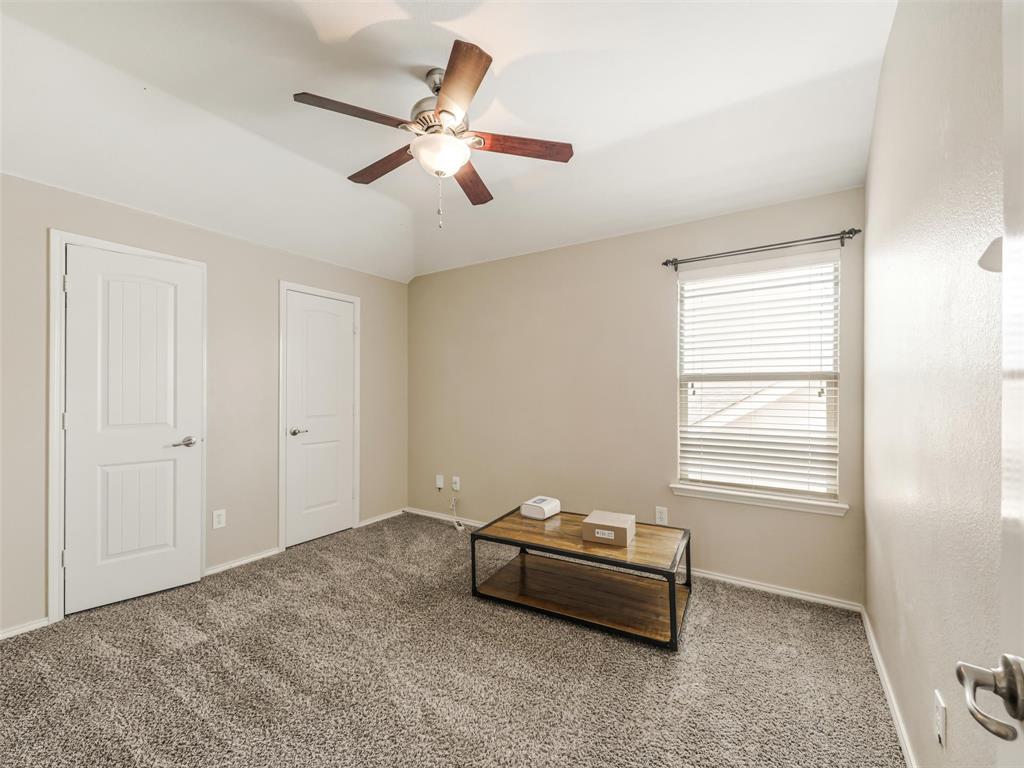 Neutral wall color, carpeted flooring, vaulted ceiling, ceiling fan with light kit, and two interior doors