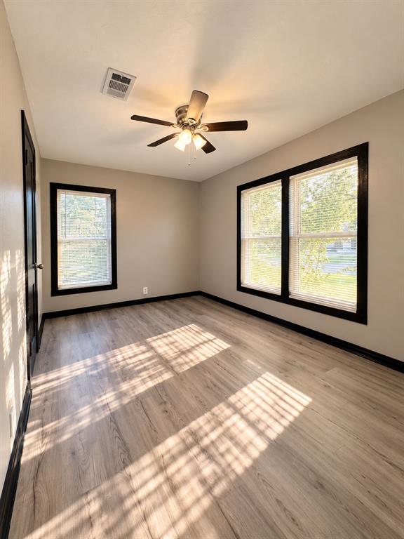 Bright secondary bedroom featuring multiple windows and plenty of natural light.