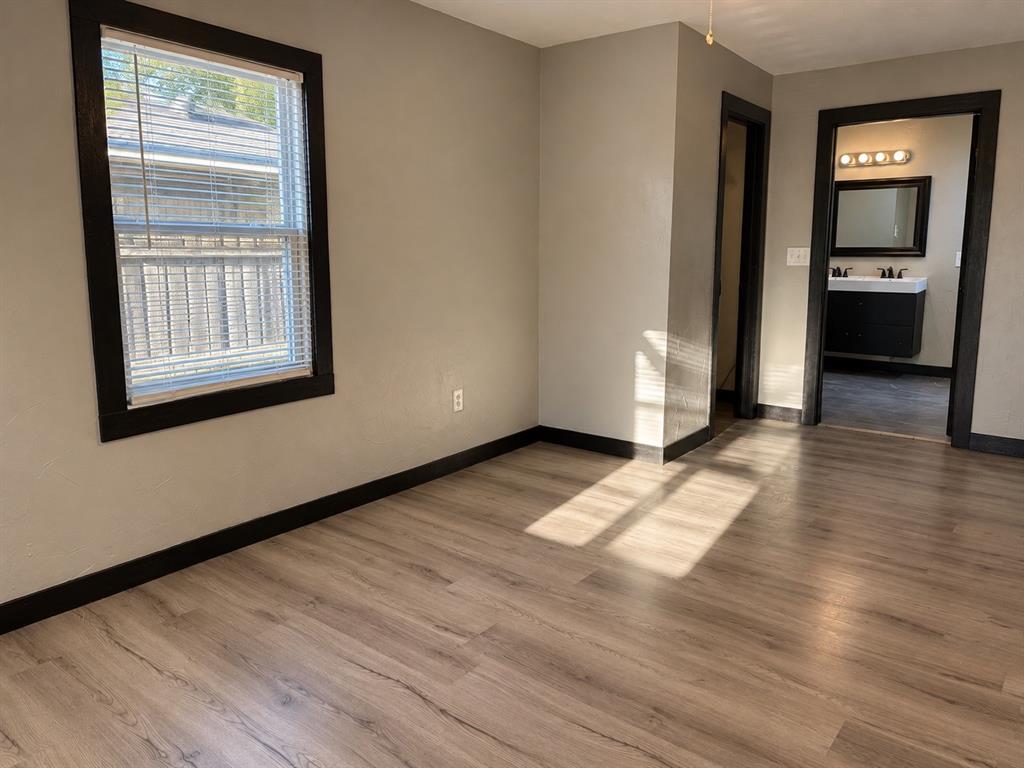 Another perspective showcasing the primary bedroom’s layout and available space.